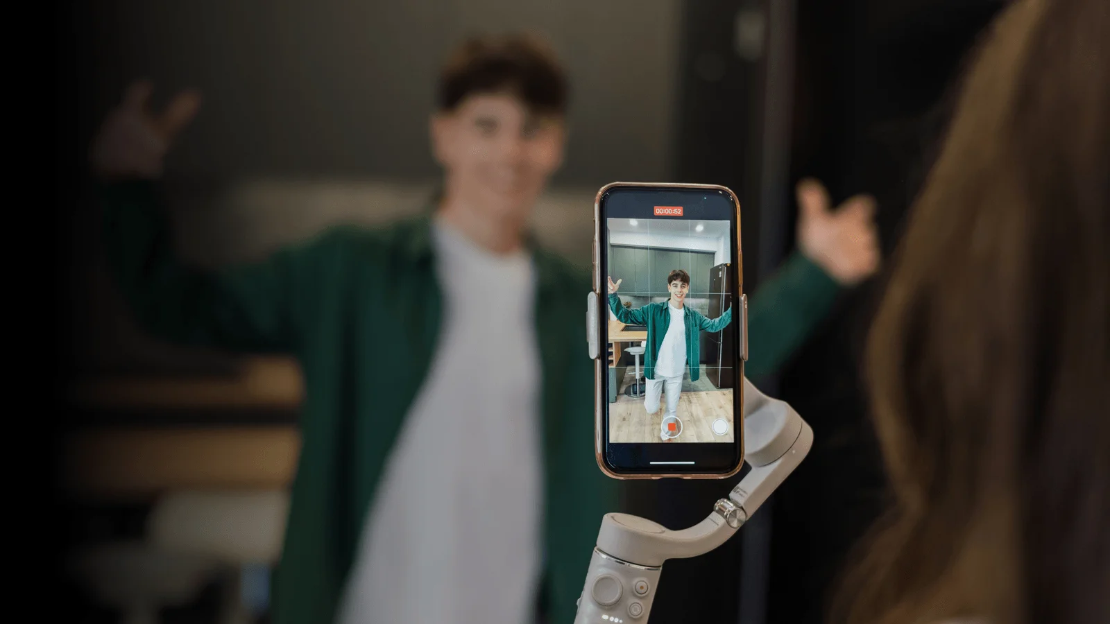A person displays a smartphone with a robotic arm on the screen